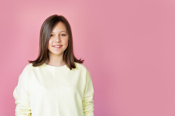Fototapeta premium teen girl smiling over pink background
