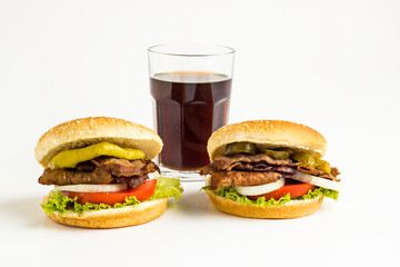 Delicious Burger made with Traditional Turkish Doner Kebab,tomato,pickle,lettuce and onion rings on the white background with cold drink.