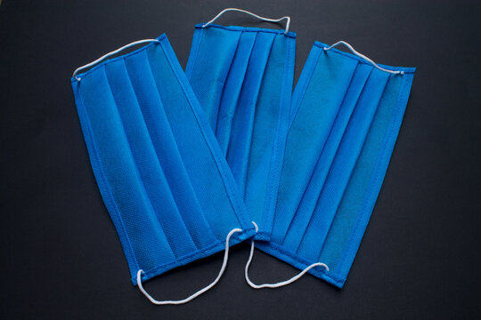 Three blue masks on black background.