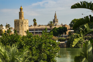 Seville, Spain - Sept. 23, 2013: Torre del Oro with  the La Giralda in the distance and the river in the foreground