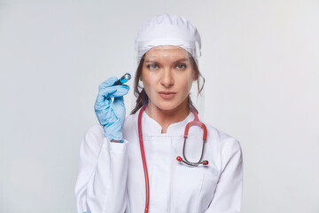 Medical concept of a female doctor in a white coat with a stethoscope, doctor. A female hospital worker looks at the camera and smiles, Studio, White background