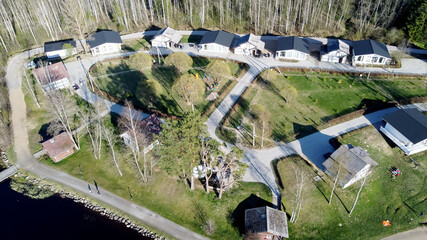 Aerial view of the lake Borisovskoye, the forest and the settlement in autumn day, Borisovo,...