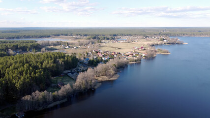 Aerial view of the lake Borisovskoye, the forest and the settlement in autumn day, Borisovo,...