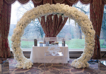 wedding ceremony set up with floral arch