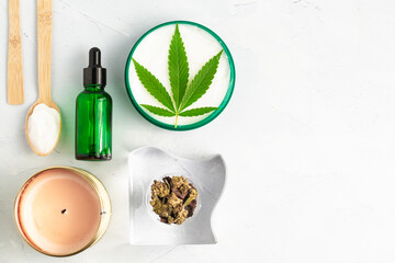 CBD cream infused with cannabis extract for an all natural skin care solution, photography flat lay of cannabis products. Medical use for treatment  of topical skin conditions and joint pains. 