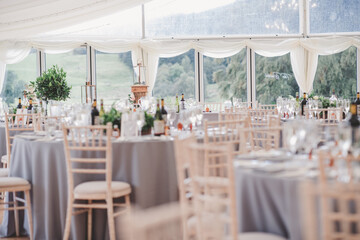 Tables and chiavari chairs set up for wedding in marquee