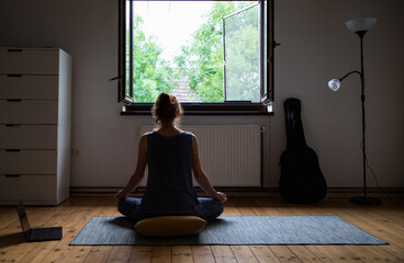 woman doing yoga at home mental health