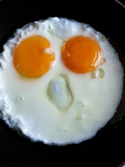 fried eggs in a frying pan