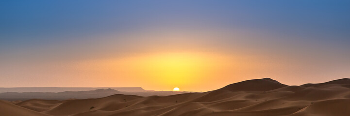 Obraz na płótnie Canvas Merzouga in the Sahara Desert in Morocco. Web banner in panoramic view.
