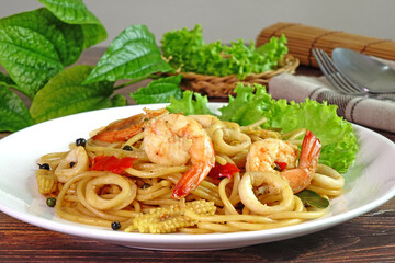 Spaghetti : Spicy seafood spaghetti, Thai style spicy and herbs spaghetti. Famous fusion Italian food in Thailand, selective focus