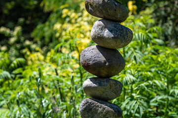 Stacked rocks in a garden, meditation focus for wellness
