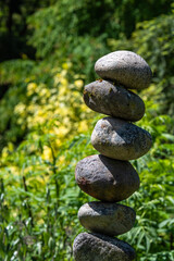 Fototapeta na wymiar Stacked rocks in a garden, meditation focus for wellness 