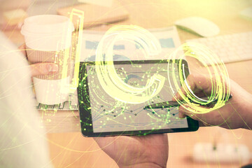Double exposure of man's hands holding and using a phone and crypto currency blockchain theme...