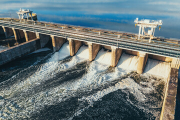 Hydroelectric dam or hydro power station at water reservoir, aerial view from drone. Draining water...