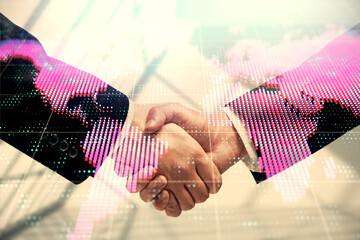 Double exposure of business theme hologram and handshake of two men. Success concept.
