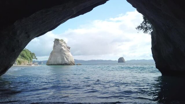 4k forward tracking motion of the rock formation know as Cathedral Cove on the coromandel Peninsula,tourist destination which became famous because of a movie film location,north island,New Zealand 