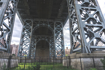 View of bridge from below. Williamsburg bridge with view of Lower East Side Public Housing