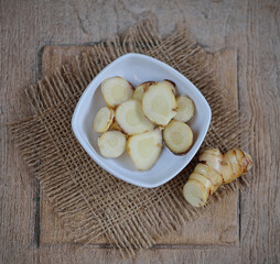 fresh galangal on wooden surface background.