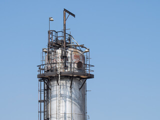 Petro chemical refinery pipes and cracking towers against a blue sky