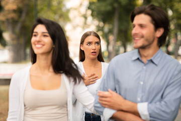 Woman Seeing Cheating Boyfriend Dating With Other Girl In Park