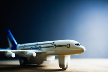 White blue toy plane Placed on a black background Light comes out from the side. Copy space concept. Impact of COVID-19, impact on airlines, air transportation.