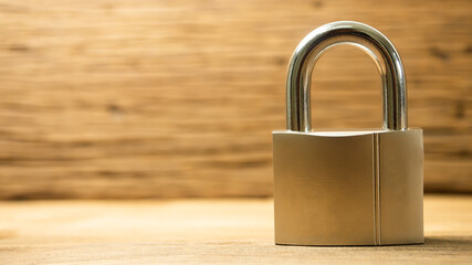 The golden key is on the brown wooden floor. There is a copy space on the front corner. concept Lock house, stay at home for life