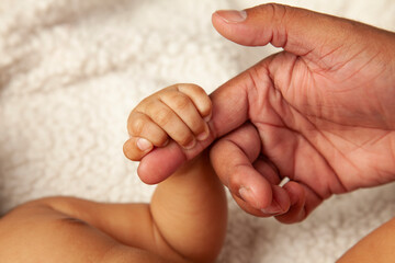 Tiny baby hand gripping onto daddy's finger &ndash; Father's day