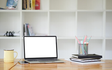 Office desk Workspace stuff with notepad, laptop and coffee cup mouse notepad shot.