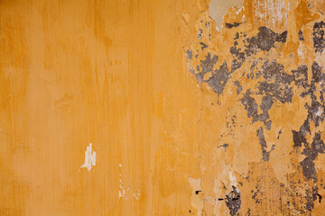 Old yellow wall with cracked