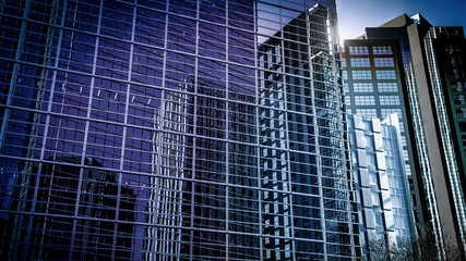 Fototapeta na wymiar ミラー状の窓ガラスに映り込んだ高層ビルのイメージ素材