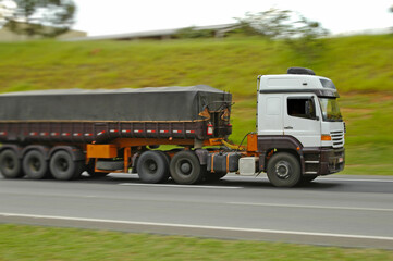 fast no brand dump semi truck loaded on roadway