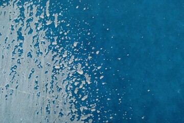 White paint splatter on the blue wall