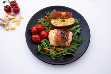 Chicken breasts filled with creamy parmigiana stuffing and wrapped in prosciutto