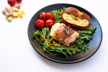 Chicken breasts filled with creamy parmigiana stuffing and wrapped in prosciutto