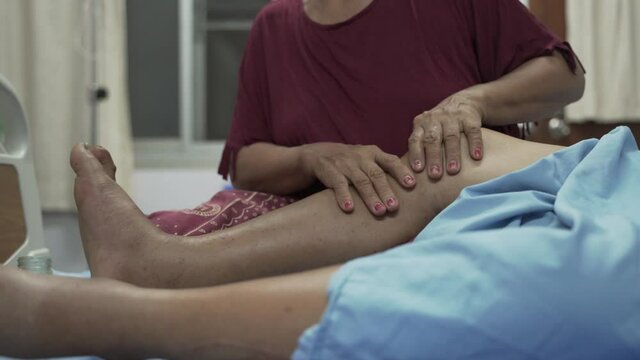 Hands massaging swollen leg, ankle and feet for Edema patient