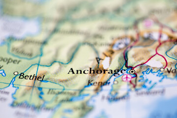 Shallow depth of field focus on geographical map location of Anchorage city United States of America USA continent on atlas