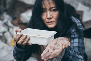 poor people,homeless or beggar begging for help sitting at dirty slum.concept for poverty...