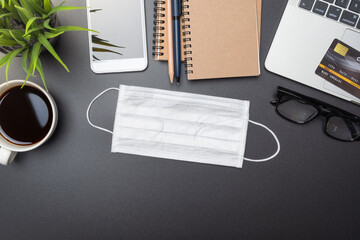 Flat lay of office desk for work from home, workspace with laptop and smartphone, credit card shopping online concept to prevent epidemic