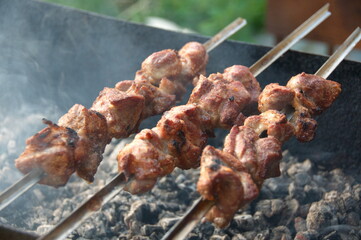 Cooking roasted over an open fire skewers of pork. shish kebab. shashlik.