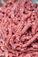 Extreme close-up view of raw minced meat after meat grinder