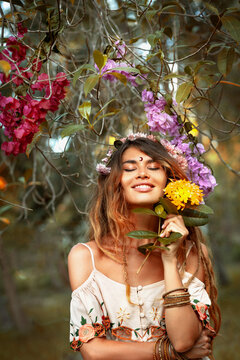 beautiful young woman wearing wreath outdoors portrait with eyes closed
