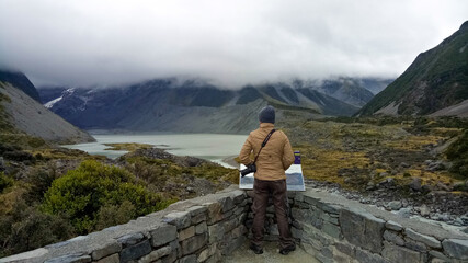 Fototapeta na wymiar A man walking inside Mount Cook National Park in New Zealand