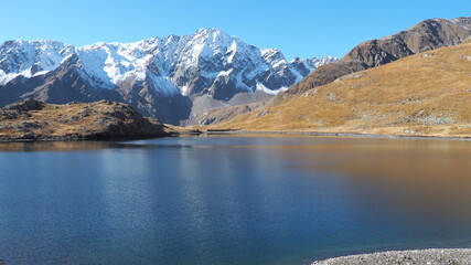 Italian Alps. Italy. Wonderful view of the a natural alpine lake. The Black lake close to Gavia mountain pass. In the background the snowy Alps