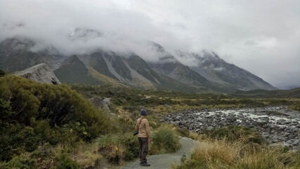 Fototapeta premium A man walking inside Mount Cook National Park in New Zealand