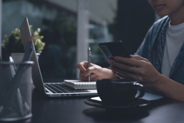Asian woman working from home and online learning at night