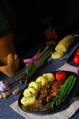 dumplings with beef goulash and green asparagus