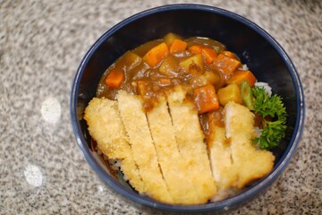 Close up of chicken katsu curry in a bowl.