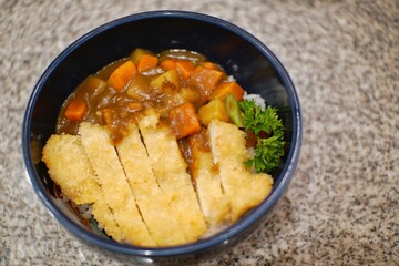 Close up of chicken katsu curry in a bowl.