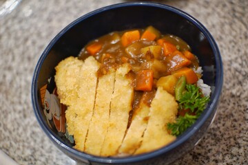 Close up of chicken katsu curry in a bowl.