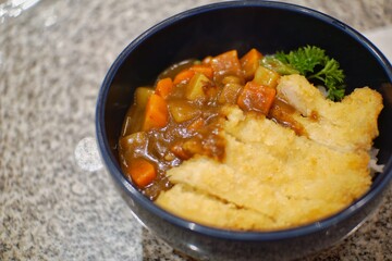 Close up of chicken katsu curry in a bowl.